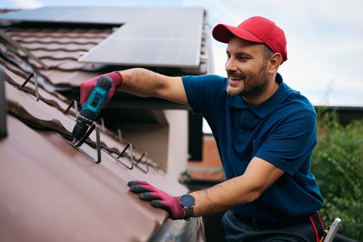 Roofer maintaining the roof of a residential home