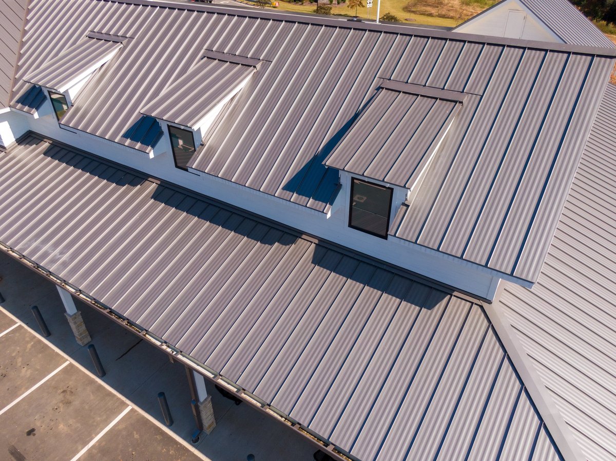 Drone aerial view of commercial buildings with standing seam metal roofs