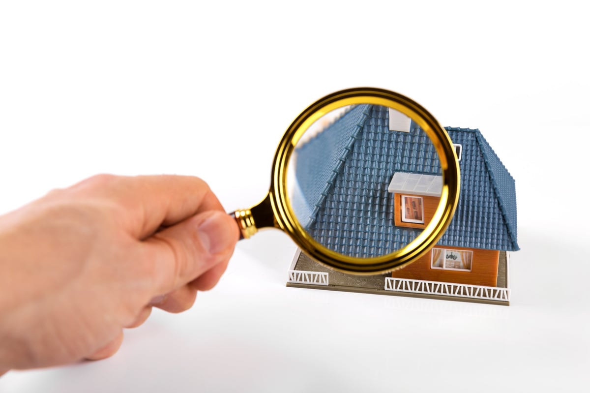 Real estate and roofing inspection report on a clipboard